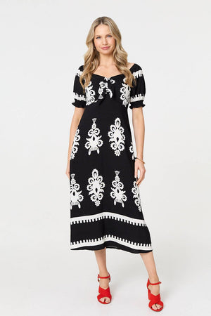 Black | Printed Puff Sleeve Tie Front Midi Dress : Model is 5'10