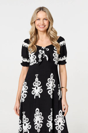Black | Printed Puff Sleeve Tie Front Midi Dress : Model is 5'10
