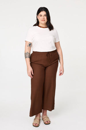 Brown | Curve Tie Waist Wide Leg Trousers : Model is 6