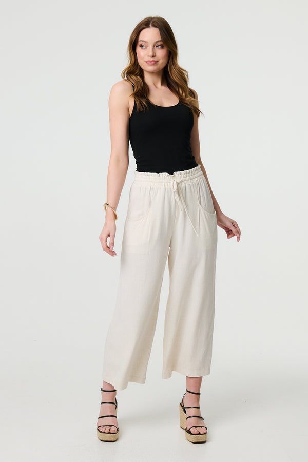 Beige | Elasticated Waist Crop Wide Leg Trousers : Model is 5'9"/175 cm and wears UK8/EU36/US4/AUS8
