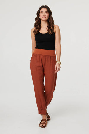 Rust | Relaxed Linen Blend Tapered Trousers : Model is 5'9