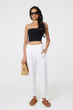 White | Relaxed Linen Blend Tapered Trousers : Model is 5'8
