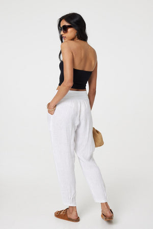 White | Relaxed Linen Blend Tapered Trousers :  Model is 5'8