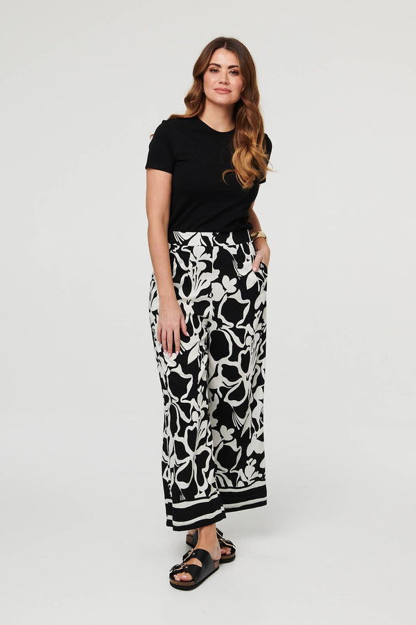 Black | Abstract Floral Wide Leg Trousers : Model is 5'9"/175 cm and wears UK10/EU38/US6/AUS10