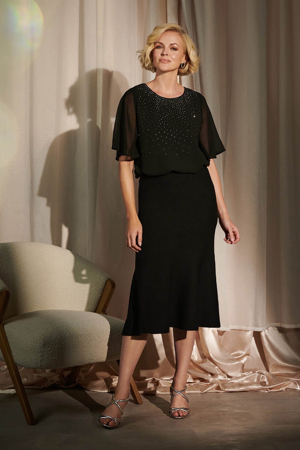Black | High Waist A-Line Midi Knit Skirt : Model is 5'10"/178 cm and wears UK10/EU38/US6/AUS10