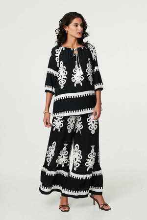 Black | Ikat Print Tassel Tie Neck Blouse
